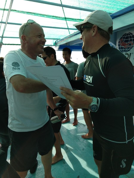 Neil hands out the diploma to Frank