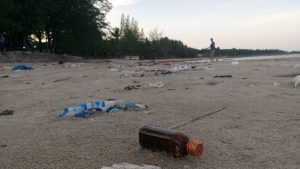 A glass bottle on the beach.