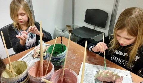 Children are painting their art work.